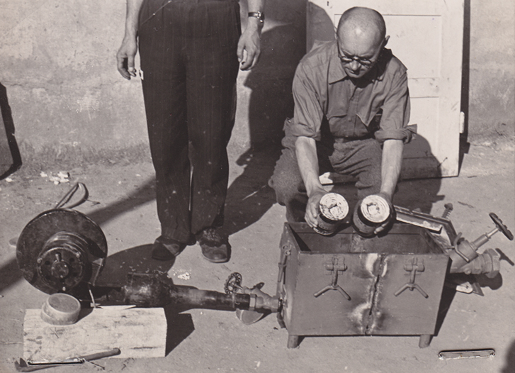 Lt. Jack Taylor with the gas filling apparatus of the gas chamber, May 1945 (photo credits: US National Archives and Records Administration)